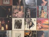 a lot of records on the wall of a room