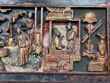 a picture of a wooden carving of a group of people