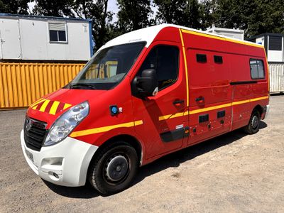 a red and yellow van parked in a parking lot