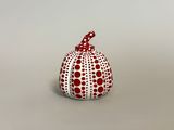a white and red dotted pumpkin sitting on top of a table