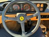 a steering wheel and dashboard of a sports car