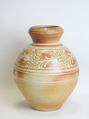 a vase that is sitting on a white surface