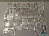 many different types of necklaces and bracelets on the table