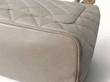 a white purse that is sitting on a white surface