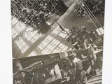 a black and white photo of people working in a factory