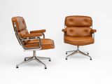 an image of a pair of brown leather office chairs on casteors