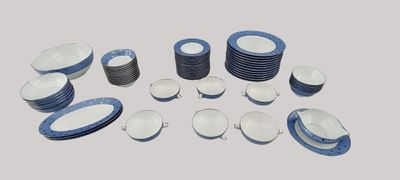 many plates and bowls arranged together on the table