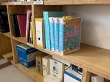 a book shelf with books on it in a room