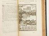 an open book with a picture of a city on it