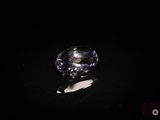 an image of a purple diamond sitting on top of a black surface