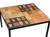a small table with a tiled top on a white background