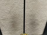 a close up of a pair of earrings on a stand