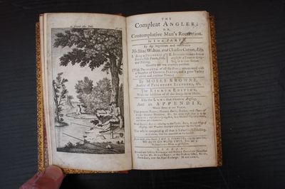 an open book with a picture of a man sitting on a bench in front of a tree