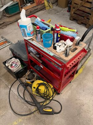 a red work bench with tools on it in a garage