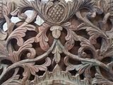 a wooden carving on the wall of a building