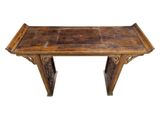 an image of a wooden table with carvings on the top