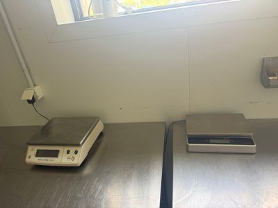 two electronic scales on a table in a room