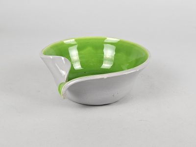 green and white ceramic bowl with a curved edge