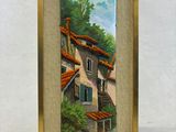 une peinture à l'huile représentant une maison dans un cadre sur fond blanc