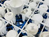 many cups and cups in a dishwasher that is filled with water