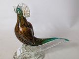 a glass bird that is sitting on top of a table