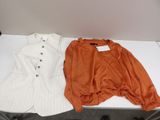 two pieces of clothing sitting on top of a table next to each other