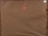 a brown piece of luggage with a red sticker on it