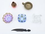 a small assortment of glass objects on a white surface
