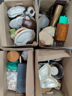 two boxes with different items in them on the floor