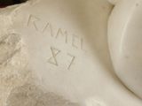 a close up of a statue of a cat with a name on it