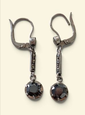 pair of black and white diamond earrings on a white background