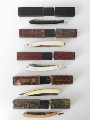 several different types of knives are lined up on a white surface