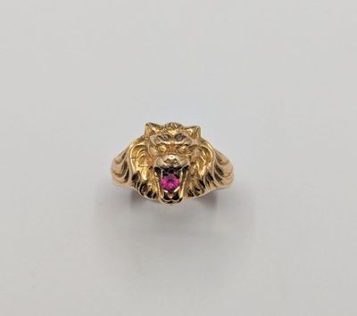 a gold ring with a pink stone in the center