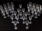 several empty wine glasses are arranged in a heart shape on a black background