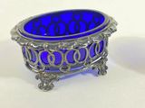 a blue glass bowl sitting on top of a white table