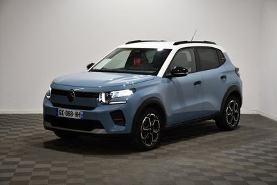 a blue suv parked in a room with a checkered floor