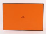 an orange box with black trim and a logo on it