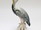 a figurine of a bird sitting on a tree stump