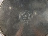 a silver plate with a picture of a man on it