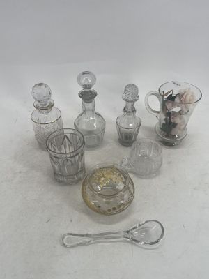 a lot of glass bottles and spoons sitting on a table