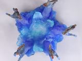 an overhead view of a group of people standing on top of a blue flower