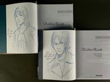 three books with drawings of people in them on a table