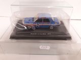 a blue and orange car in a clear display case
