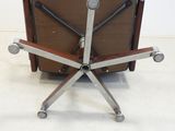 a brown chair with four metal legs and a brown chair with four metal legs and a brown chair with four metal legs and a brown chair with four metal