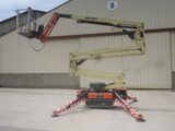a picture of a man on a cherry picker in front of a building