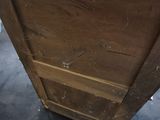 a wooden cabinet with a drawer on top of it