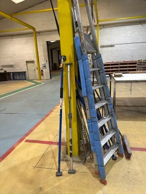 a ladder that is leaning against a pole in a building