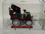 a small toy car in a clear box on a table