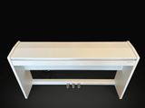 white piano bench with two keys on a black background
