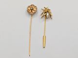 a pair of gold - plated pins with flowers and pearls